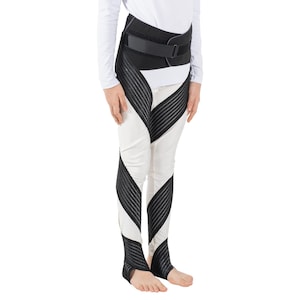 May include: A black and white support brace for the leg and hip. The brace has a wide, adjustable belt that wraps around the waist and a series of straps that extend down the leg.