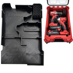 May include: Black plastic tool organizer with the text "TIDYTOOL" and "IMPACT". A red tool case contains two drills and two batteries. The case is open, revealing the tools inside. The organizer has compartments for tools and batteries.