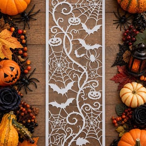 May include: A rectangular white laser-cut panel featuring a detailed Halloween-themed design with intricate spider webs, swirling vines, carved jack-o'-lanterns, and flying bats, presented as a flat decorative piece with a clean cutout pattern.