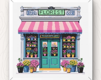 May include: A pink and white striped awning over a storefront with a green door and windows filled with colorful flowers. The sign above the door reads "FLORIST".
