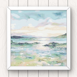 May include: A framed cross-stitch artwork depicting a seascape with a light blue sky, white clouds, and a calm ocean with green and blue water. The ocean is dotted with small islands and rocks.