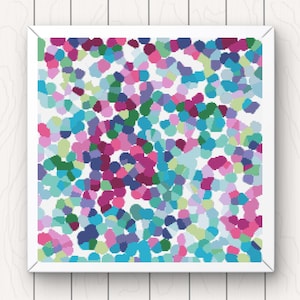 May include: A framed abstract artwork with a pattern of small, irregular shapes in pinks, blues, greens, and purples. The artwork is set against a white background, and the frame is white.