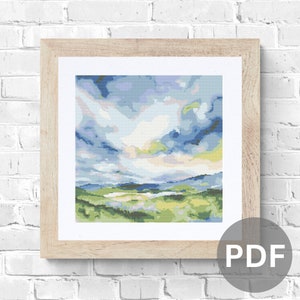 May include: A framed painting of a landscape with a blue and green colour scheme. The painting depicts a field with a distant mountain range and a cloudy sky.
