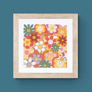 May include: A framed print featuring a retro-style floral pattern with a variety of colorful flowers in shades of orange, yellow, pink, red, and green.