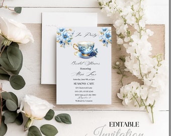 May include: A blue and white teacup with floral accents sits on a saucer. The invitation is for a bridal shower for Alisa Lane, to be held at Seasons Cafe on June 9th at 3pm. The invitation includes the cafe's address and RSVP information.