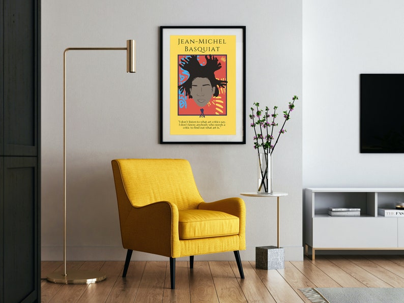 May include: A framed poster with a colorful illustration of Jean-Michel Basquiat, a famous artist. The poster has a black frame and a white background with the text "JEAN-MICHEL BASQUIAT" at the top. The quote "I don't listen to what art critics say. I don't know anybody who really knows a critic to find out what art is." is printed below the illustration.
