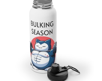 May include: White stainless steel water bottle with a silver cap and black lid. The bottle features a cartoon character lifting weights with the text "BULKING SEASON" in black. The character is blue and white with a red circle behind it.