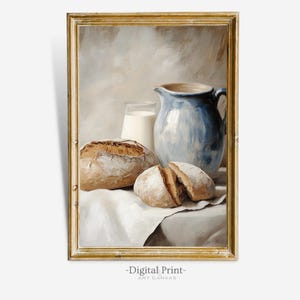 May include: A still life painting of a blue ceramic pitcher, a glass of milk, and three loaves of bread on a white tablecloth. The painting is framed in a gold frame.