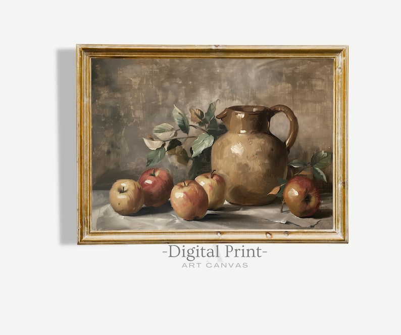 May include: A still life painting of a brown ceramic pitcher with a handle, surrounded by red apples and green leaves on a white tablecloth. The painting is framed in a gold frame.