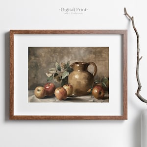 May include: A framed digital print of a still life painting featuring a brown ceramic pitcher and red apples on a white tablecloth. The background is a muted brown color.