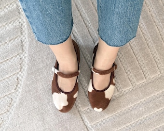 ample project . furry cow print mary janes . purely handmade