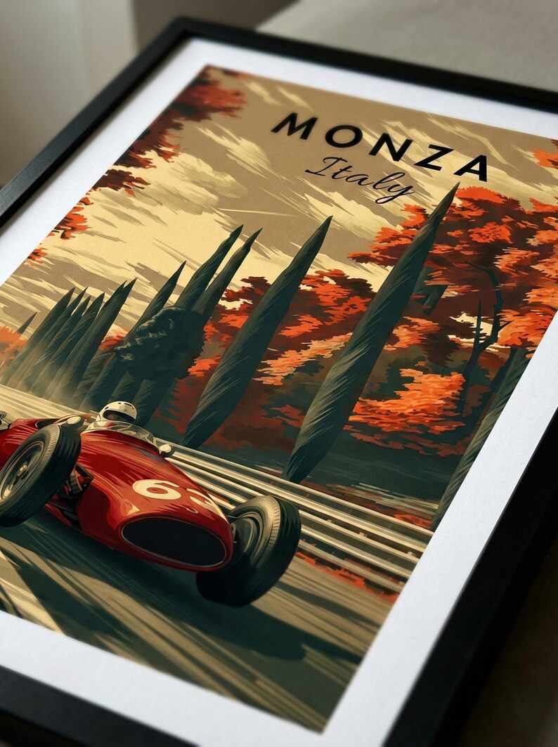 May include: Framed vintage-style poster featuring a red race car speeding on a track. The poster has the text "MONZA Italy" at the top, with a backdrop of trees in autumn colors. The race car has the number 63 on its side.