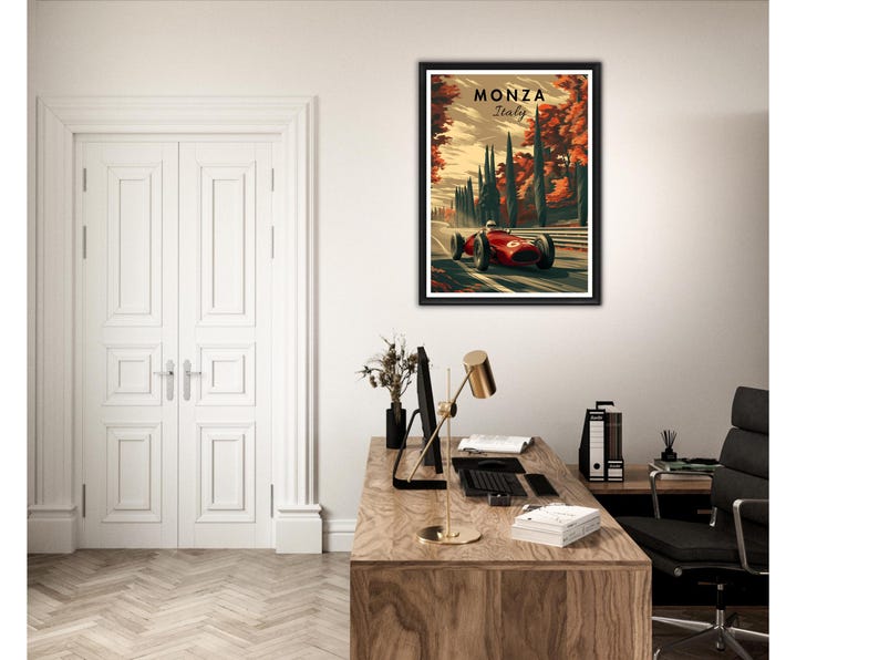 May include: Framed art print featuring a vintage race car speeding along a track, with the text "MONZA Italy" at the top. The artwork has a retro style with a color palette of red, green, and brown. The print is displayed in a black frame.