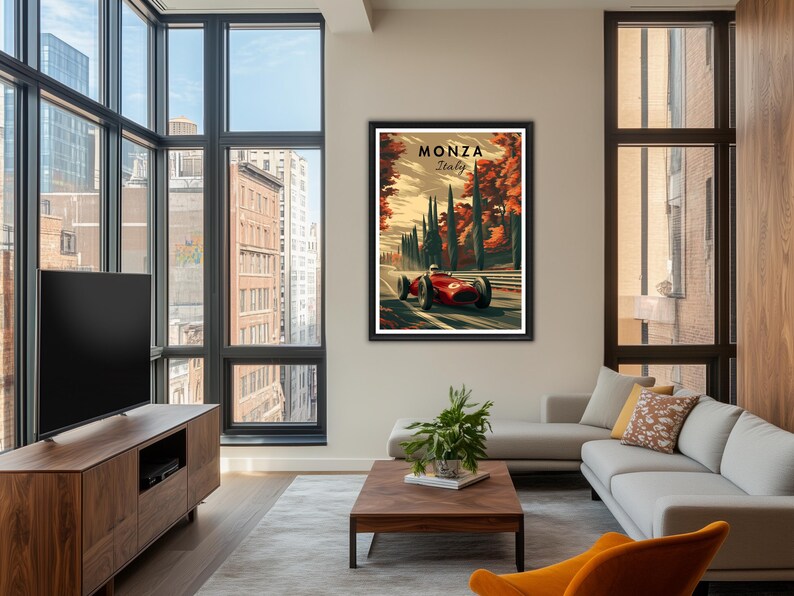 May include: Framed Monza Italy vintage racing poster. The artwork features a red race car speeding along a track, with the text "Monza Italy" at the top. The background includes trees and a sunset sky. The poster is displayed in a modern living room.