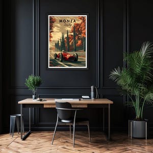 May include: A framed art print featuring a vintage race car speeding along a track in Monza, Italy. The artwork showcases a red race car against a backdrop of trees and the text "Monza Italy". The print is displayed on a black wall.