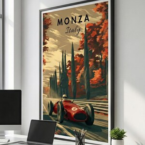 May include: A framed art print featuring a vintage race car speeding along a track in Monza, Italy. The artwork showcases a red race car with the number 6, set against a backdrop of tall trees and autumn foliage. The text "MONZA Italy" is displayed at the top.