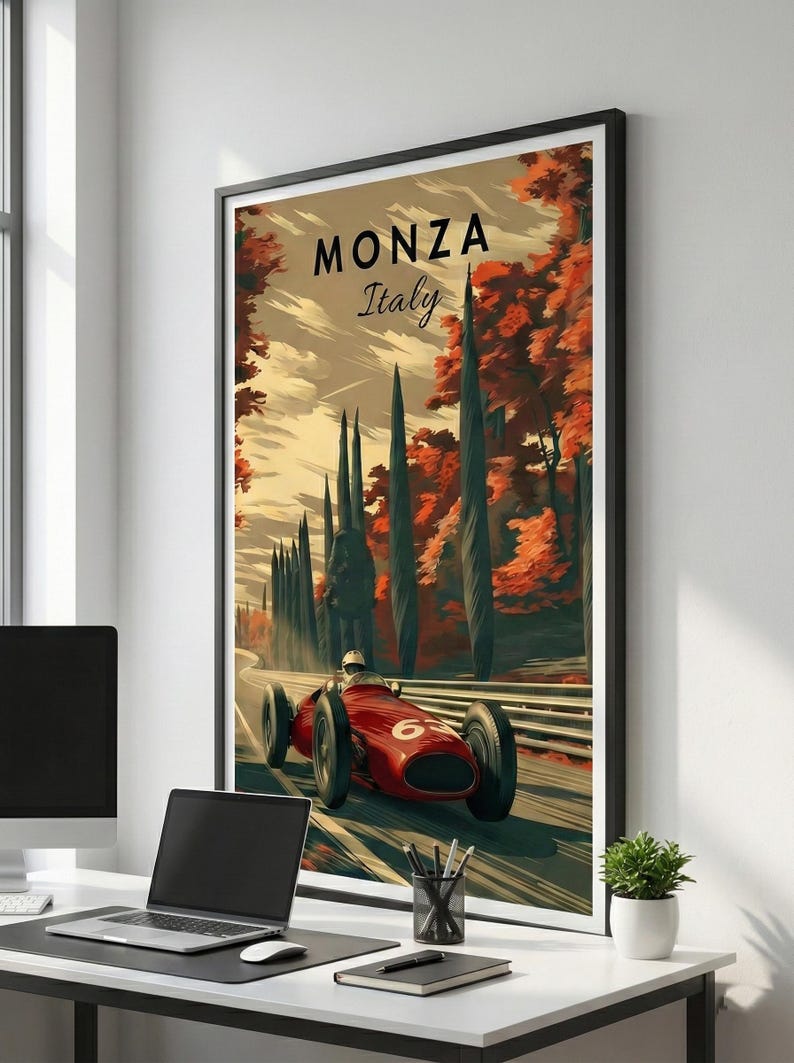 May include: A framed art print featuring a vintage race car speeding along a track in Monza, Italy. The artwork showcases a red race car with the number 6, set against a backdrop of tall trees and autumn foliage. The text "MONZA Italy" is displayed at the top.