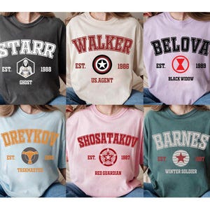 May include: A collection of six oversized t-shirts in various colors, each featuring a different name in a collegiate-style font. Each shirt includes a graphic and the year of establishment.