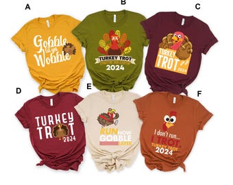 May include: Six different t-shirt designs featuring turkeys and Thanksgiving-themed text. The shirts are in various colours, including mustard yellow, olive green, burgundy, maroon, beige, and orange.