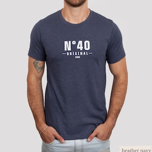 May include: A heather navy blue short-sleeve t-shirt featuring white text on the chest that reads N&deg;40 ORIGINAL 1986. The shirt has a crew neckline and a standard fit, constructed from a soft, heathered fabric with a visible textured appearance.