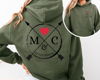 May include: Olive green hoodie with a large graphic on the back featuring a red heart, the letters "M" and "C", and the Roman numeral "IV.VIII.MMXXI". The front of the hoodie has a smaller matching graphic. The word "grün" is at the bottom left.