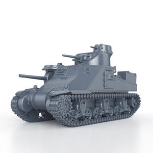 May include: A gray metal model of a military tank with a detailed design. The tank has a turret with a cannon and tracks on the bottom.