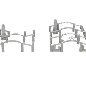 Op de afbeelding: Een set grijze, steenachtige bouwstenen met bogen en torens. De blokken zijn in twee rijen gerangschikt, met de bogen tegenover elkaar. De torens bevinden zich aan de uiteinden van de rijen.