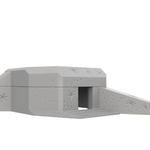 May include: A gray concrete bunker model with a small entrance and a ramp leading up to it. The bunker has a weathered, distressed look with small holes and marks on the surface.