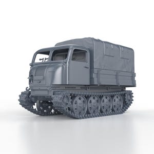May include: A grey, military-style tracked vehicle with a canvas top. The vehicle has a large windscreen and a driver's compartment. The vehicle is on a white background.
