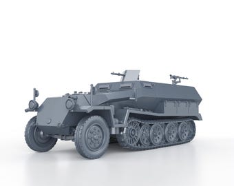 May include: A gray military half-track vehicle with a machine gun mounted on the top. The vehicle has a canvas top and a rear cargo area.
