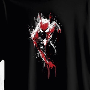 May include: Black t-shirt featuring a dynamic illustration of Spider-Man in a running pose. The artwork uses a bold red and white color scheme against a black background, with paint-like brushstrokes adding a sense of movement and energy.