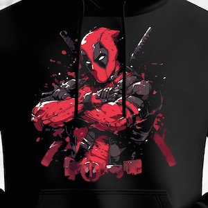 Pode incluir: Moletom preto com um gráfico de Deadpool, o personagem da Marvel Comics. A ilustração mostra Deadpool em seu traje vermelho e preto, com os braços cruzados, com um efeito de respingo. O design é em um estilo de quadrinhos ousado.