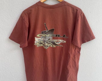 May include: A brown t-shirt with a graphic of a surfer riding a wave with the word "ONEILL" printed on it.