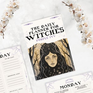 May include: A purple and white planner with the text "The Daily Planner for Witches Purple Ivy" and an illustration of a woman with long dark hair in a forest setting.