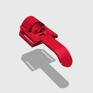 Könnte beinhalten: Ein 3D-gerenderter roter Kunststoff-Reißverschluss-Schieber mit einem gebogenen Griff und einer rechteckigen Basis. Der Schieber hat einen zylindrischen Abschnitt mit einem Schlitz und einen rechteckigen Abschnitt mit zwei parallelen Schlitzen.
