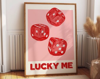 May include: A framed print with a pink background and three red dice with white dots. The text "LUCKY ME" is printed in red at the bottom of the print.