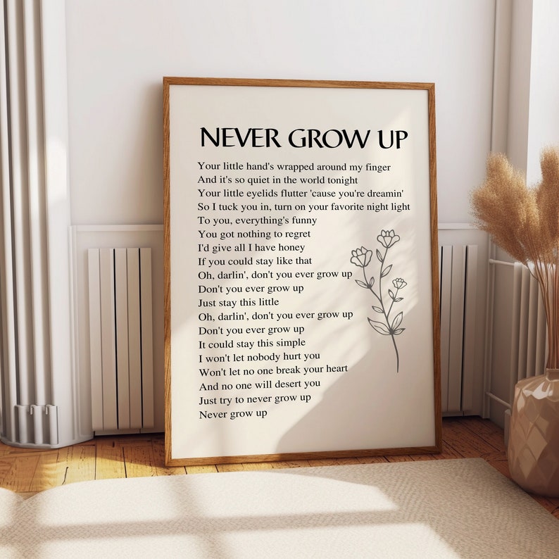 May include: A white printable poster with black text that reads "Never Grow Up" and a simple black line drawing of a flower. The text is a poem about staying young at heart.