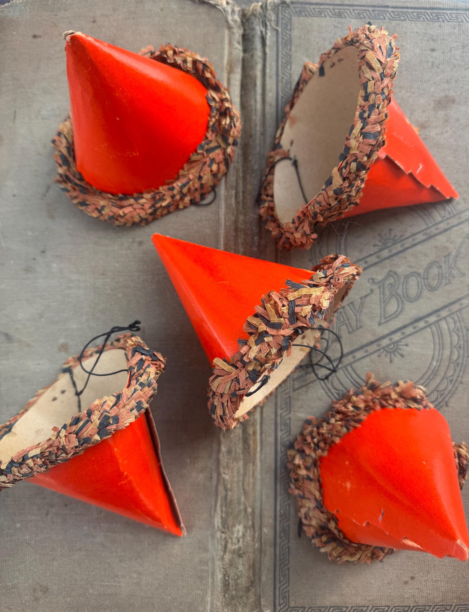 A Cone with a Soft Paper-Fringe Rim Vintage orange cardboard cones trimmed with crepe-paper fringe.