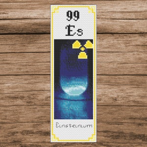 May include: A bookmark with a yellow and white design featuring the element Einsteinium, atomic number 99, with the symbol Es and a radiation symbol.