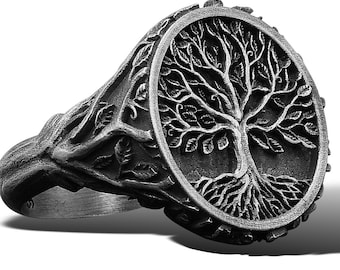 May include: A silver ring with a detailed tree of life design. The ring is made of metal and has a circular shape.