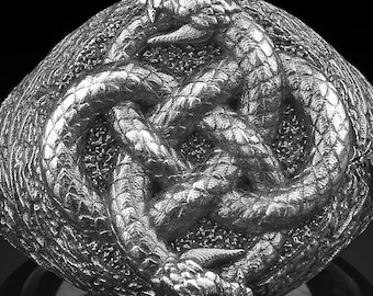 May include: A silver-colored ring featuring a detailed design of intertwined snakes forming a knot. The ring has a textured surface and a dark background, highlighting the intricate details of the serpent motif.