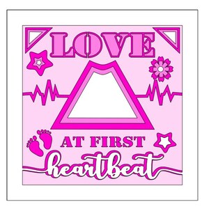 May include: Pink and white printable card with the text "LOVE AT FIRST HEARTBEAT" and a heart-shaped frame. The card also features a star, a flower, and a heartbeat graphic.