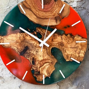 Colorful epoxy and olive wood wall clock against a light background.