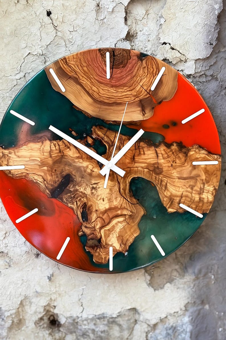 Colorful epoxy and olive wood wall clock against a light background.