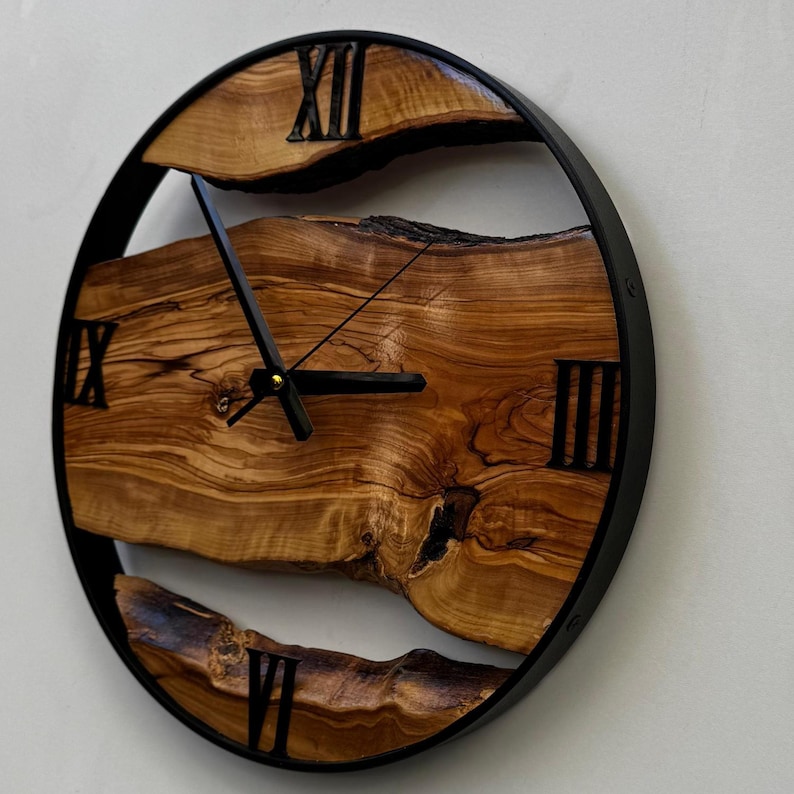 Roman numeral olive wood clock with natural color variations and polished texture.