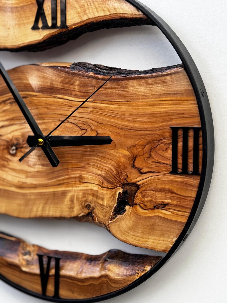 Unique handmade olive wood clock highlighting deep grain and warm tones.
