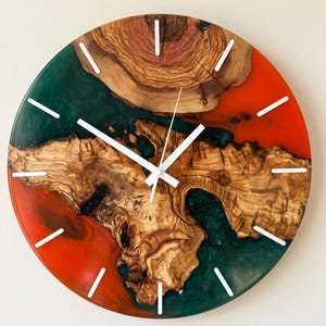 Handmade olive wood and epoxy resin wall clock featuring white. Natural live edge wood grain, and artisan craftsmanship, designed as luxury rustic wall decor for modern and farmhouse interiors.