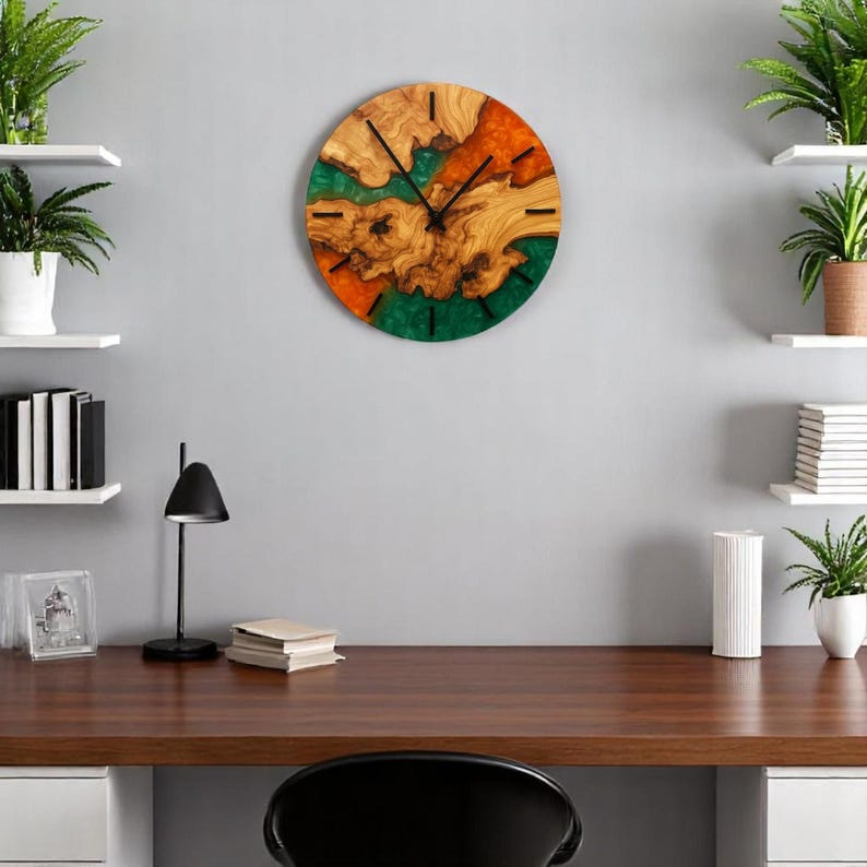 Close-up of green and orange epoxy blending with natural olive wood grain.