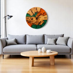 Front view of rustic-modern olive wood resin wall clock.