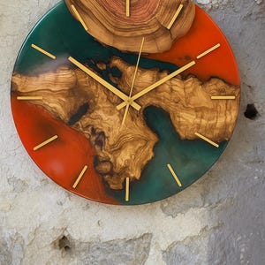 Artistic olive wood clock featuring live edge details and vibrant resin colors.